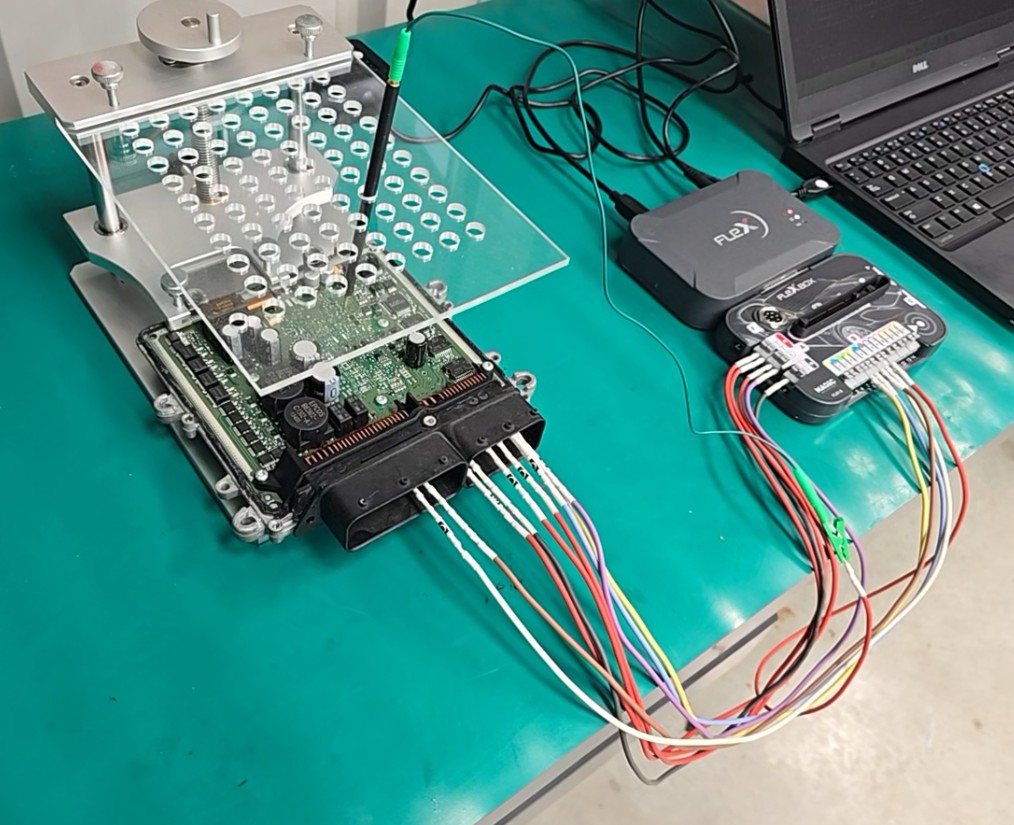 ECU open in boot/bench jig with probe frame